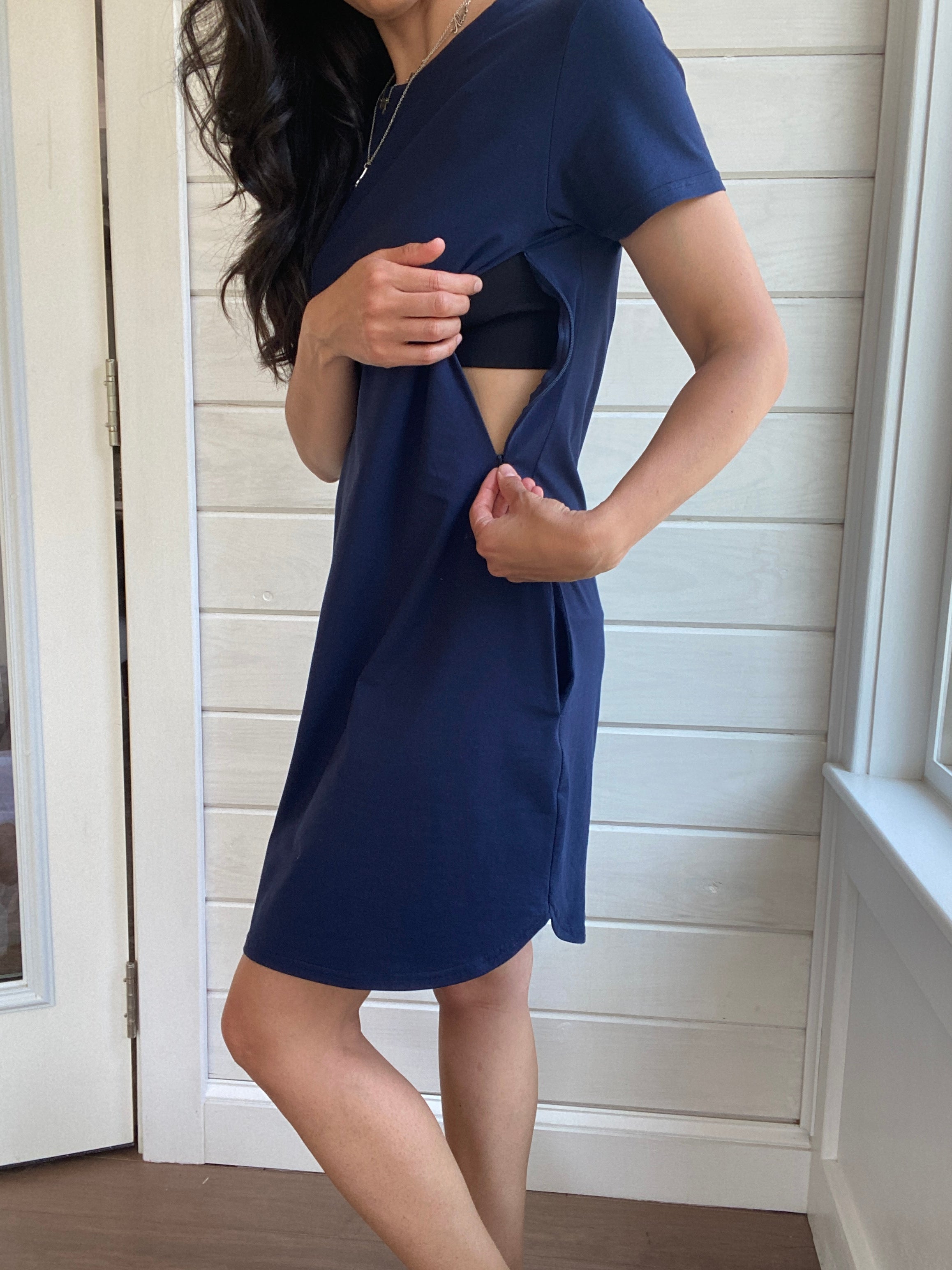 Breastfeeding T-Shirt Dress in Navy. Two Zippers on right and left side to provide accessibility to nursing mothers. Pockets, rounded hem with two small slits on either side. T-Shirt Style dress perfect to nurse your child in.