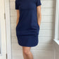 Breastfeeding T-Shirt Dress in Navy. Two Zippers on right and left side to provide accessibility to nursing mothers. Pockets, rounded hem with two small slits on either side. T-Shirt Style dress perfect to nurse your child in.